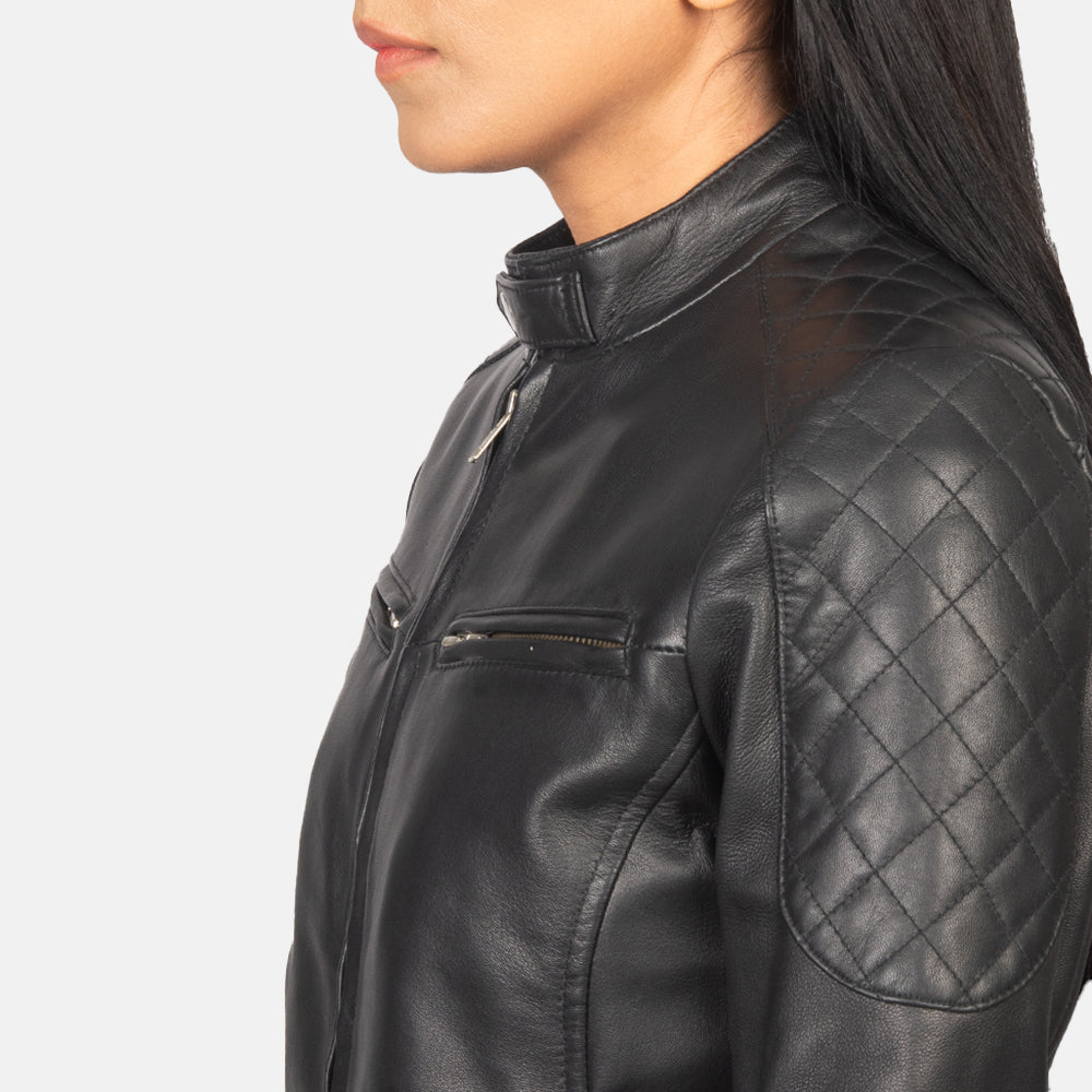 Macro view of the sleek minimalist collar design on the tan leather jacket.