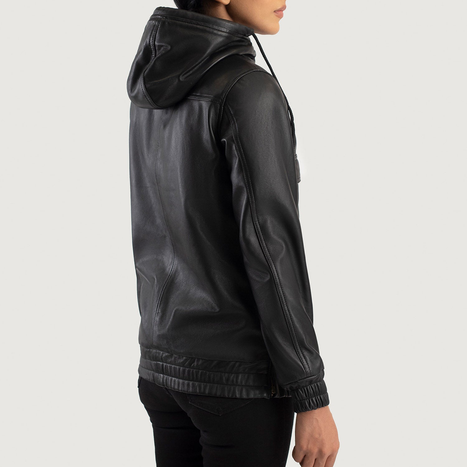 Close up of the partial front zipper closure and hardware on the black leather pullover.