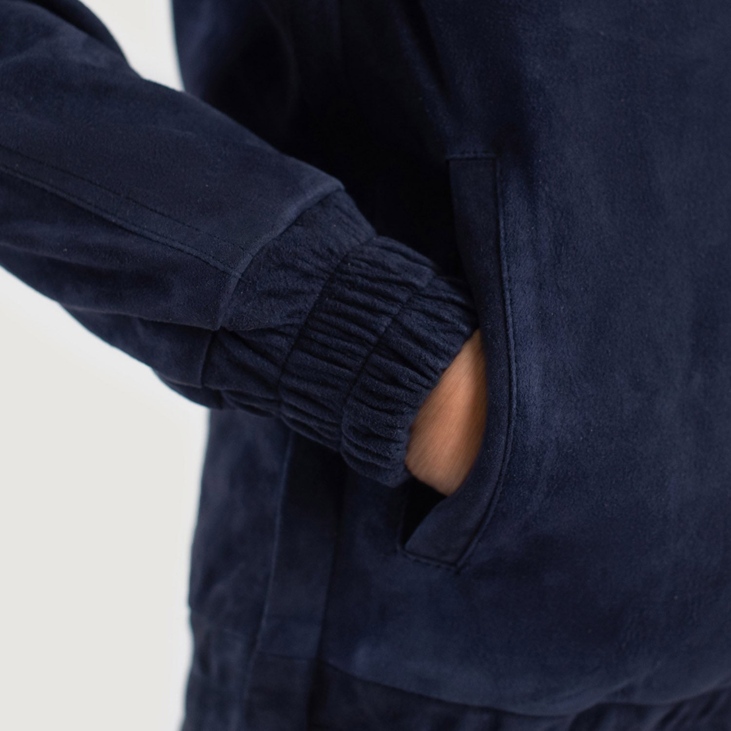 6. Macro view of quality stitching on the blue suede hood and collar.